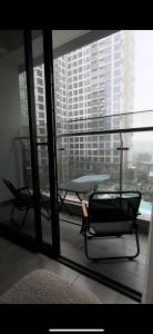 a room with a table and a chair on a balcony at Denzi home in Ho Chi Minh City