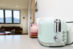a toaster sitting on top of a kitchen counter at Retro Gallery Escape in the Heart of Braddon - Hosted by Canstay in Braddon +28 photos