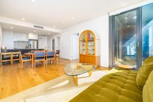 a living room with a couch and a table at Retro Gallery Escape in the Heart of Braddon - Hosted by Canstay in Braddon