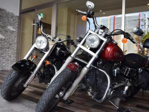 a red motorcycle parked in front of a building at Community & Spa Naha Central Hotel in Naha