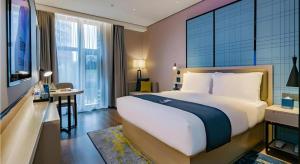 Katil atau katil-katil dalam bilik di Echarm Hotel Xi'an Dayan Tower Datang Lively District