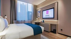Katil atau katil-katil dalam bilik di Echarm Hotel Xi'an Dayan Tower Datang Lively District