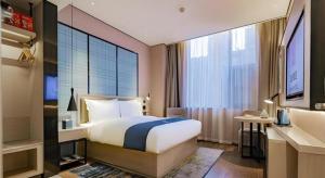 Katil atau katil-katil dalam bilik di Echarm Hotel Xi'an Dayan Tower Datang Lively District