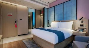 Katil atau katil-katil dalam bilik di Echarm Hotel Xi'an Dayan Tower Datang Lively District