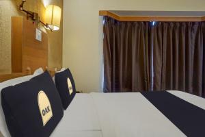 Postel nebo postele na pokoji v ubytování Townhouse Oak Orchard Hotel