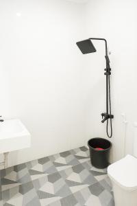 a bathroom with a shower and a toilet and a sink at Hotel Madiyara in Mukomuko +16 photos
