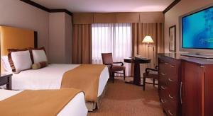 a hotel room with two beds and a flat screen tv at Ameristar Casino Hotel Kansas City in Randolph