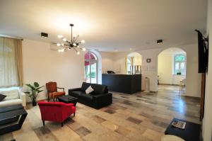 a living room with a couch and a chair at Hotel Villa Laurel in Lovran