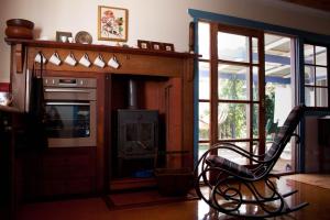 a living room with a chair and a stove at Lotti's House in Albany