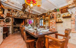 a kitchen with a long wooden table and chairs at Cozy Home In Maslenica With Kitchen in Maslenica +54 photos