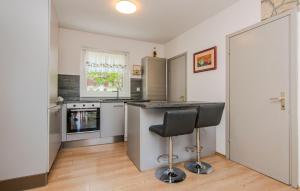 a kitchen with a counter and a bar stool at Cozy Home In Maslenica With Kitchen in Maslenica
