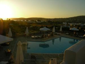 a pool with tables and umbrellas at a resort at Eri Hotel in Parikia