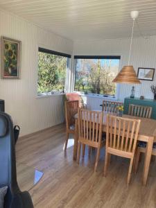 a dining room with a wooden table and chairs at Holiday Home By The Water In Rødvig, Stevns in Rødvig