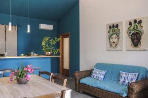 a living room with a table and a couch at Villa Bruca 2 appartamenti al mare in Caronia Marina