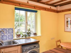a kitchen with a sink and a window at Riverside Cottage in Keswick +15 photos