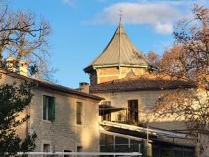 an old building with a tower on top of it at Château de Livière in Calvisson +17 photos