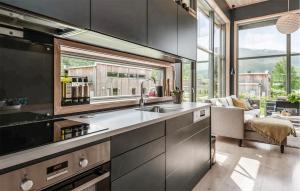 a kitchen with a sink and a living room at Lovely Home In Ål With House Sea View in Ål +9 photos