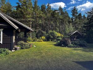 a yard in front of a house with trees at Rustic Guesthouse in Pine Forest 