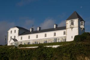 a large white building on top of a hill at Stella Maris Shore House in Ballycastle