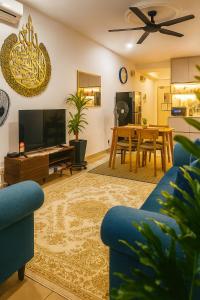 a living room with a blue couch and a tv at Z&A CozyHome -Homestay in Seksyen 13, Shah Alam, MSU, AEON Mall in Shah Alam