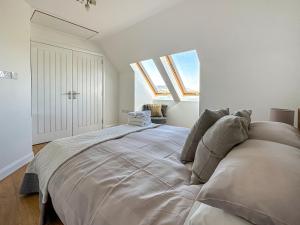 a large bed in a white room with skylights at Sealladh Apartment - Ukc6792 in Port Appin