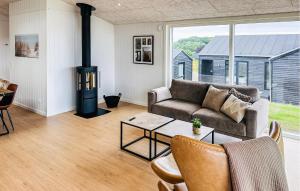 a living room with a couch and a wood stove at Lovely Home In Haderslev With Sauna in Haderslev
