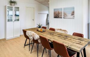a dining room with a wooden table and chairs at Lovely Home In Haderslev With Sauna in Haderslev