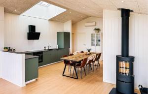 a kitchen and dining room with a wood stove at Lovely Home In Haderslev With Sauna in Haderslev