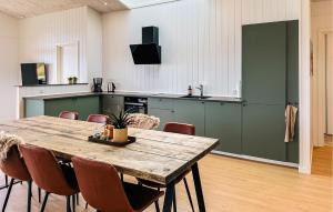 a large kitchen with a wooden table and chairs at Lovely Home In Haderslev With Sauna in Haderslev
