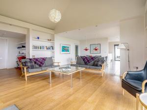 a living room with two couches and a table at The Two Byres in Trumpan