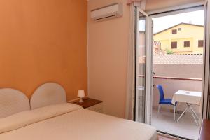 Postel nebo postele na pokoji v ubytování Hotel Costa d'Oro