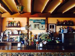 a bar with a lot of bottles on the wall at El Tinao in Yegen