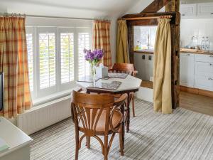 a kitchen with a table and some chairs and a table and a kitchen at The Beehive in Betley