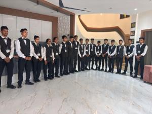 a group of men in suits and ties posing for a picture at BUDDHA HERITAGE RESORT in Bodh Gaya +106 photos