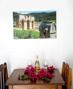 a table with two wine glasses and flowers on it at Flower Hotel Patara in Patara