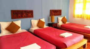 una camera con due letti con lenzuola rosse di Umphangburiresort a Umphang