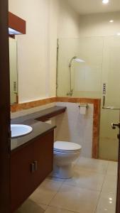 a bathroom with a toilet and a sink at Keke homestay sanur in Sanur