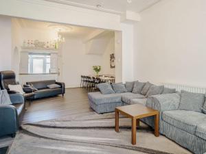 a living room with two couches and a table at Highbury in Blackpool
