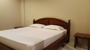 a bed with two pillows on it in a room at Keke homestay sanur in Sanur
