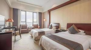 Postel nebo postele na pokoji v ubytování New Century Hotel Ningbo Xiangshan Shipu + 213 fotografií