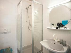 a white bathroom with a shower and a sink at Pension Haus Brieden in Winterberg +40 photos