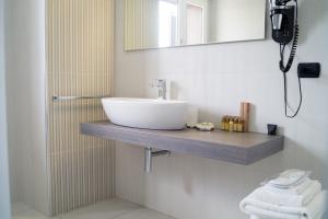 a bathroom with a sink and a mirror at Areté Luxury Room in Reggio di Calabria
