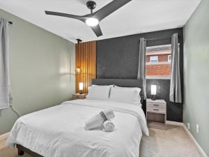 a bedroom with a large white bed with a ceiling fan at Contemporary Lux Pad Patio in Alexandria +19 photos