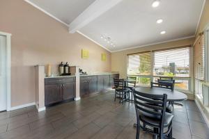 a kitchen with a table and chairs and a table and a counter at Rodeway Inn Albany in Albany