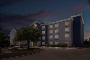 a rendering of a hotel at night at Comfort Suites Austin Airport in Austin