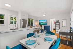 a kitchen and dining room with a table and chairs at Condo by the Beach King Bed Lush Patio w BBQ Breakers Key Six H0MES in Fort Lauderdale +11 photos