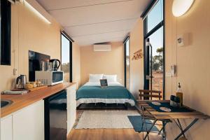 a small bedroom with a bed in a tiny house at The Buloke by Tiny Away in Chirrup