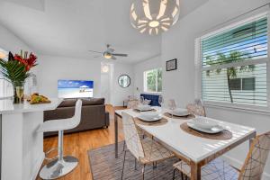 a dining room and living room with a table and chairs at Condo by the Beach King Bed Lush Patio w BBQ Breakers Key Five H0MES in Fort Lauderdale