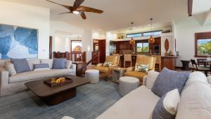 a living room with a couch and a table at SEA TO SKY Stunning 3BR Villages Home With Three Master Suites in Waikoloa