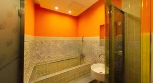 a bathroom with a sink and a toilet in it at Dalian Household Theme Hotel Huanghe Road Branch in Dalian